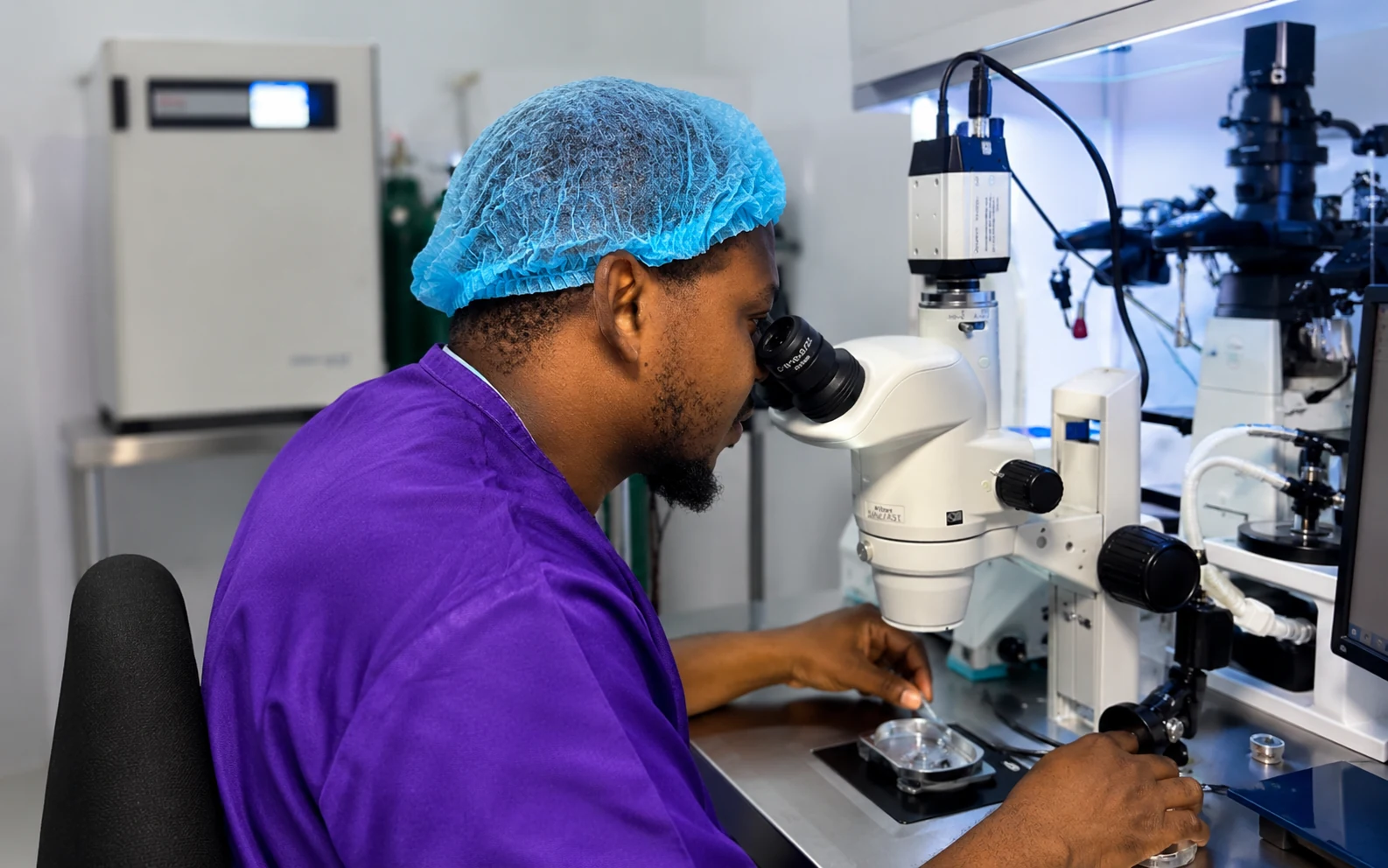 An embryologist at work at a microscope in the laboratory